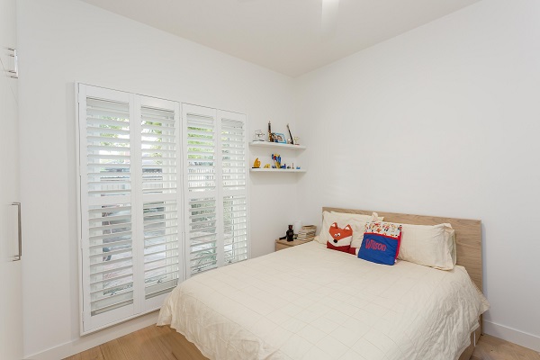 4 Panel White PVC Plantation Shutters in Bedroom Located in 3133 VIC