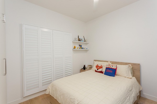 4 Panel White PVC Plantation Shutters in Bedroom Located in 3106 VIC