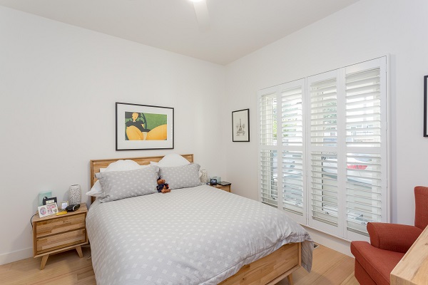 4 Panel White PVC Plantation Shutters in Bedroom Located in 3196 VIC